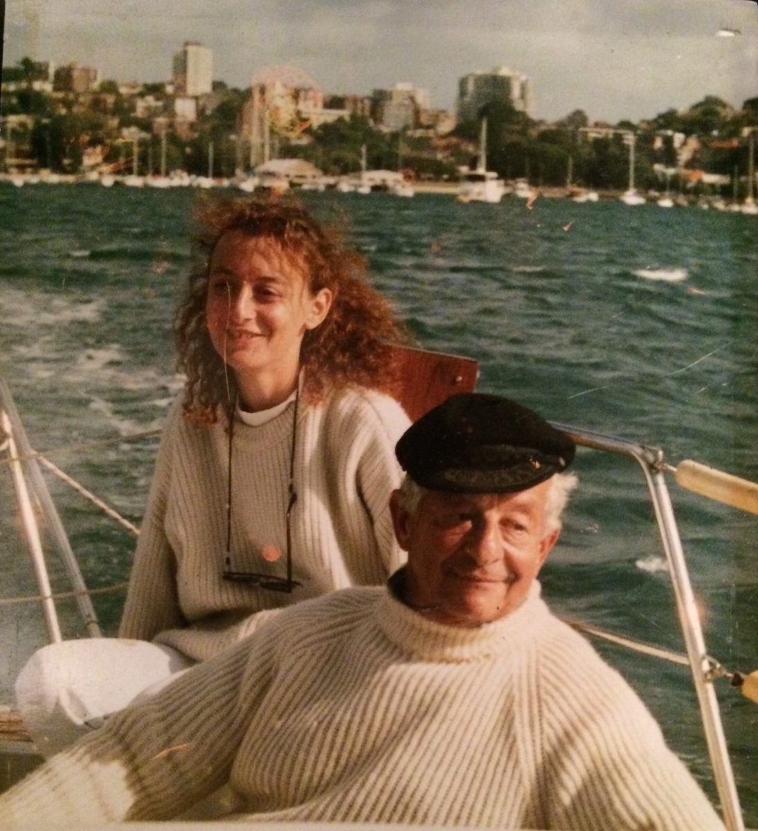 Woman and man sailing on boat in matching white jumpers 