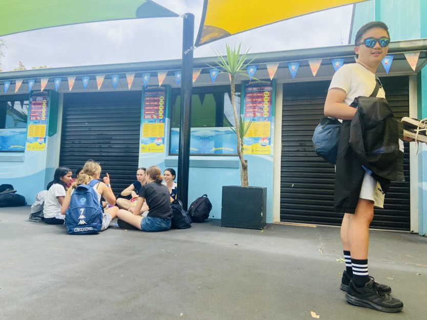 Students and a teacher outside a water park