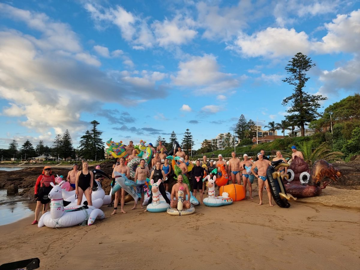 Sharkbaiters ocean swimming group on Wollongong beach with inflatable toys