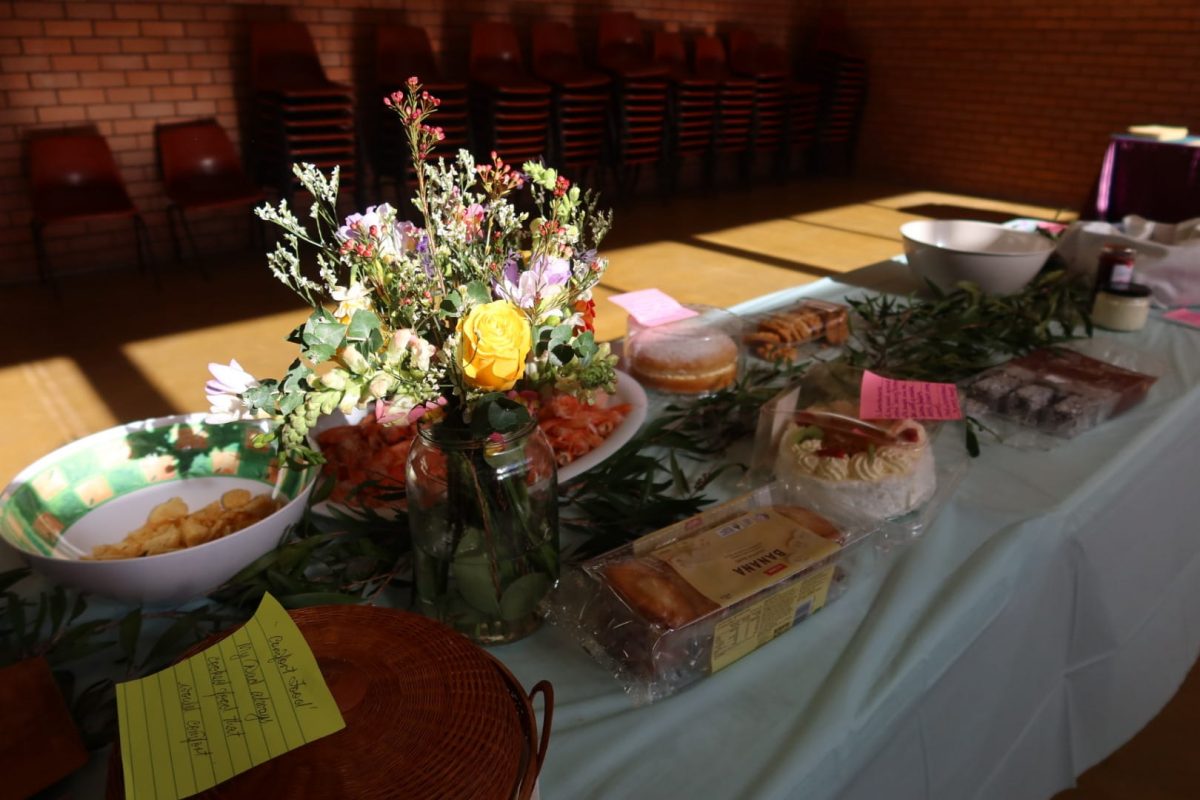 Food on a trestle table with flowers