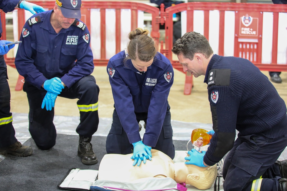 Fire and Rescue NSW performing CPR on a dummy for the ARRO Challenge. 