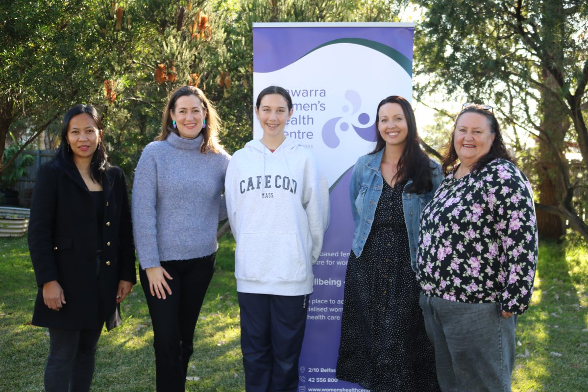 Women in front of a banner to launch the Experience into Expertise program.