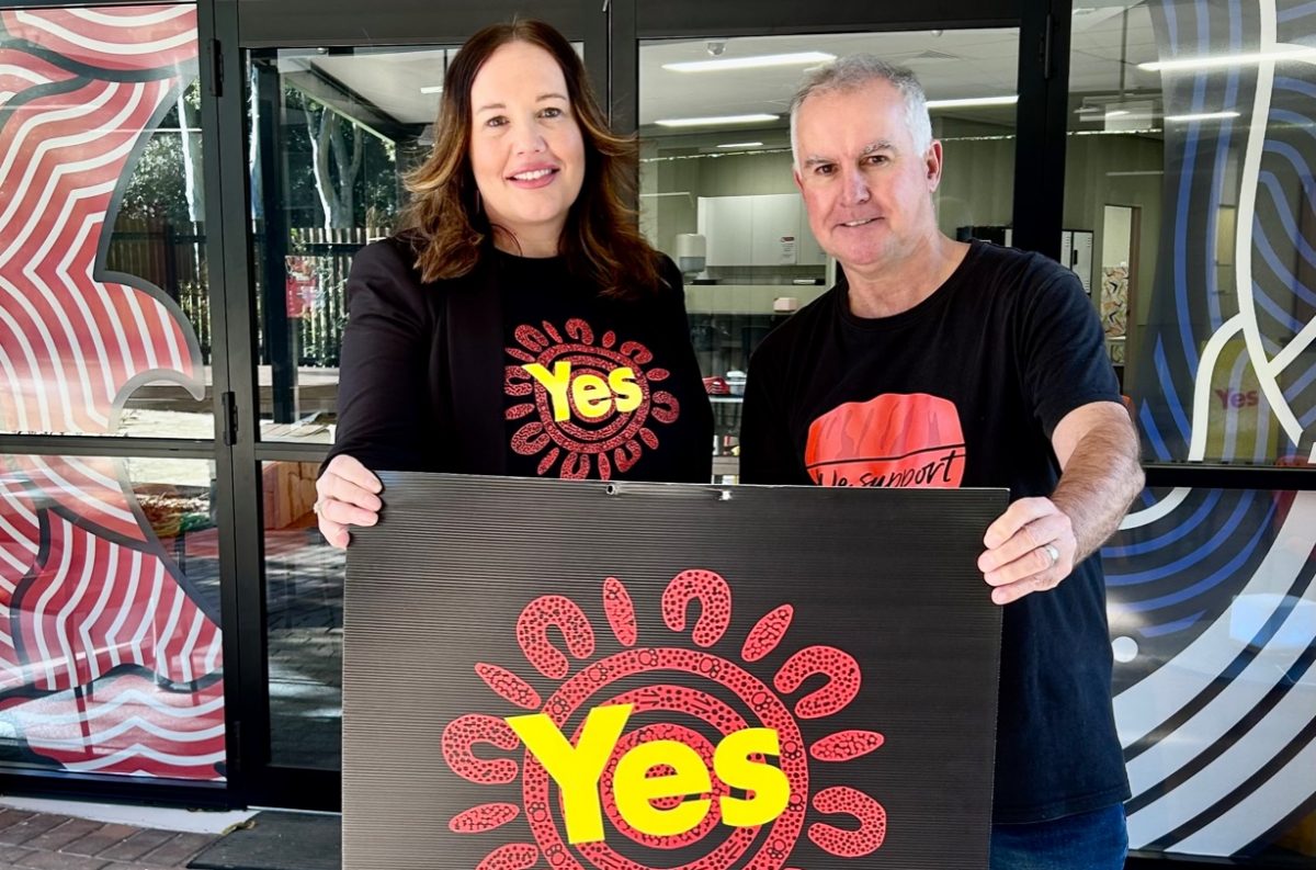 Jaymee Beveridge and Jeremy Lasek at University of Wollongong with yes referendum sign