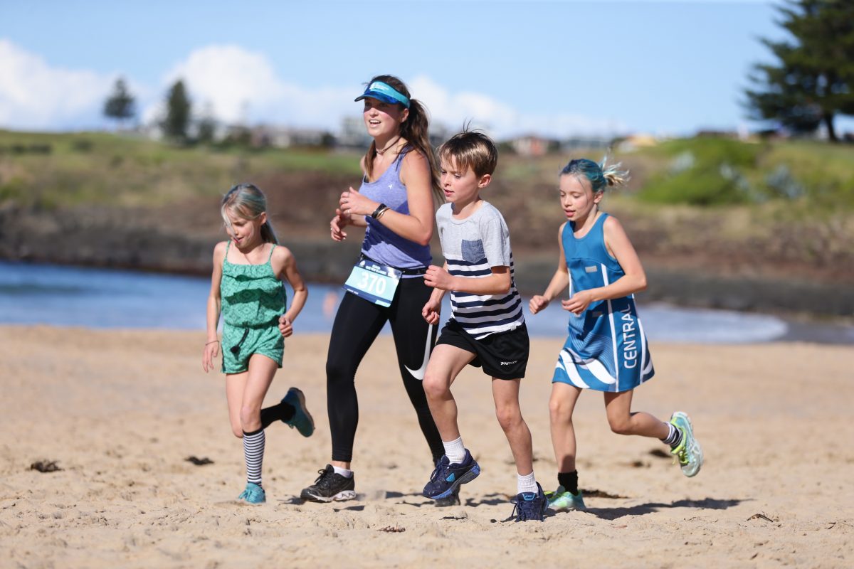 Kids running on the beach for the Kiama Coastal Classic running festival
