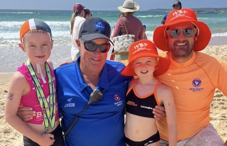 two men and two kids at beach