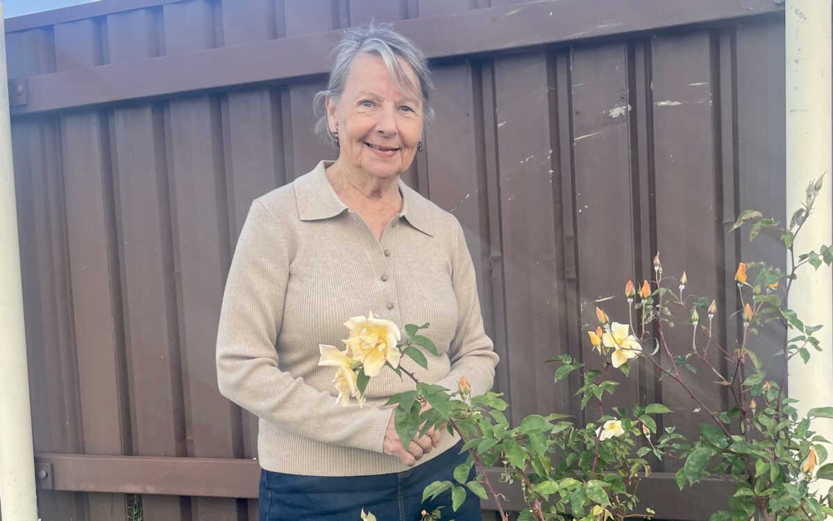 Judith Oyston next to rose bush