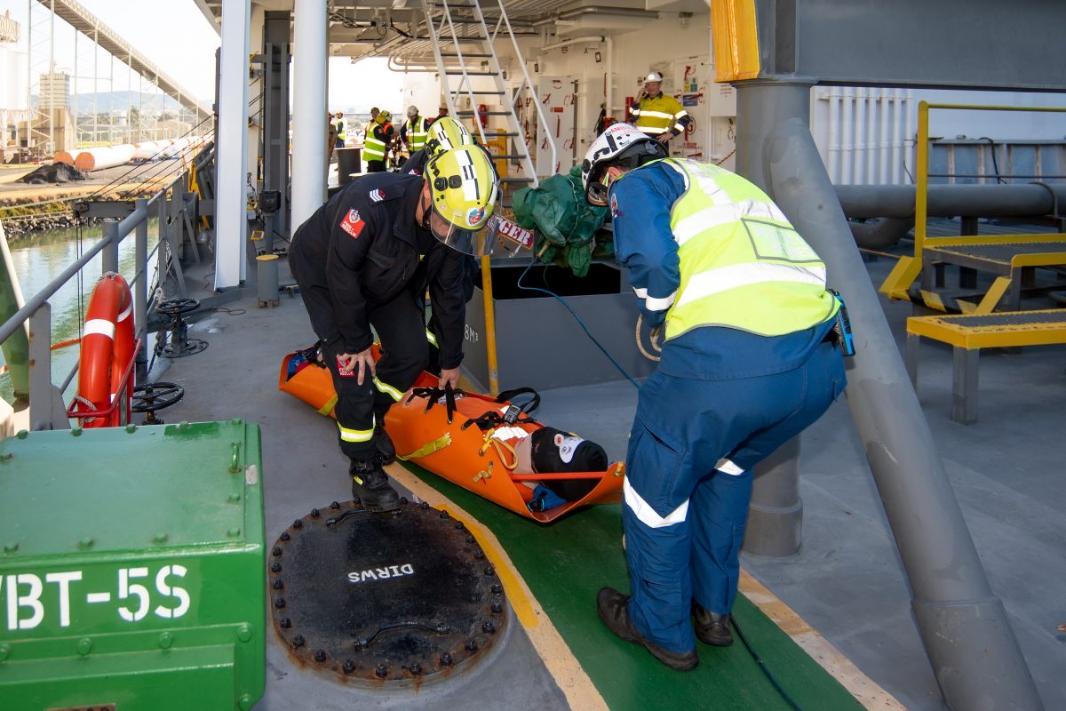 Emergency responders replicating extricating a patient from a ship 