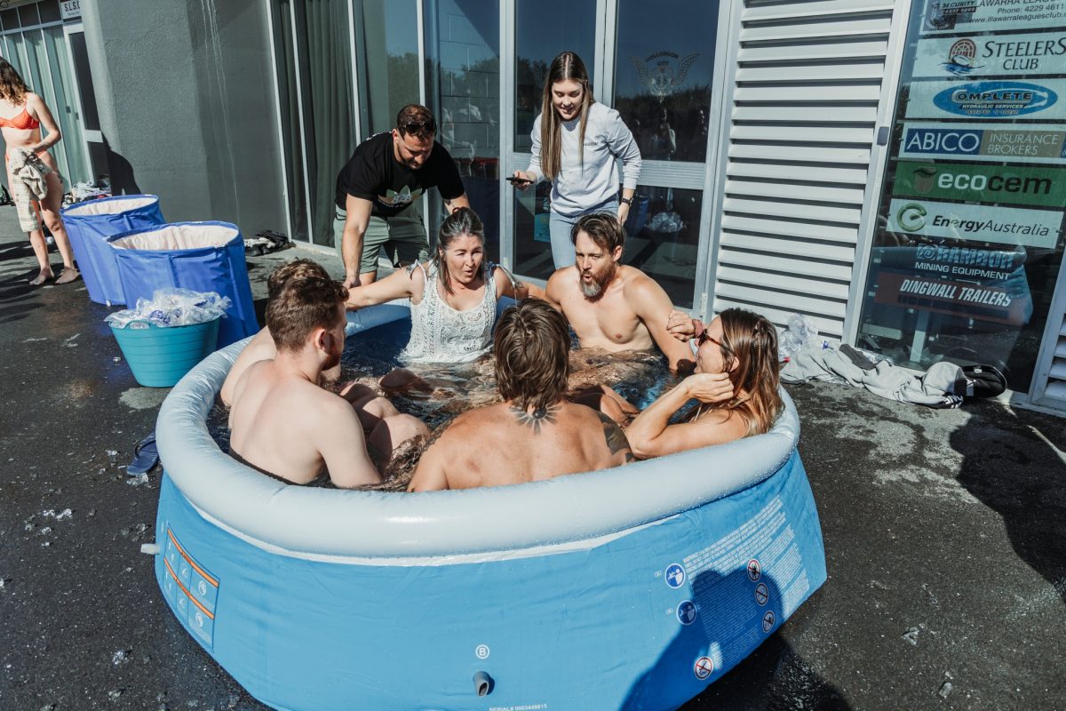 Six people in an ice bath for Talk2mebro outside City Beach in Wollongong.