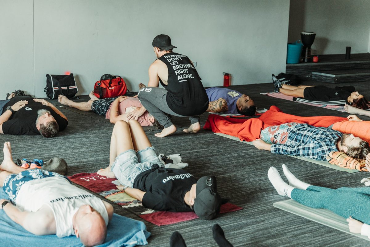 Talk2mebro participants lying on ground during breathwork sessions in Wollongong.