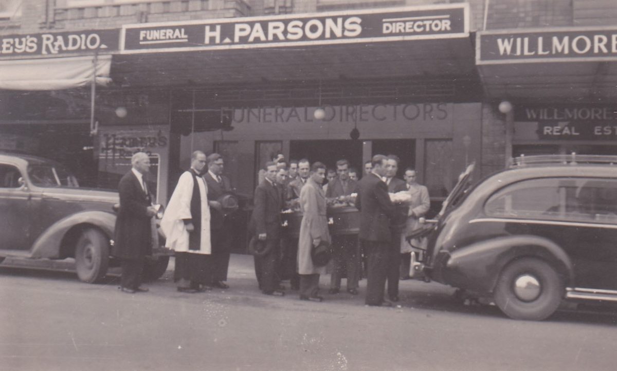Black and white photo of a funeral ceremony by H. Parsons Funeral Directors.