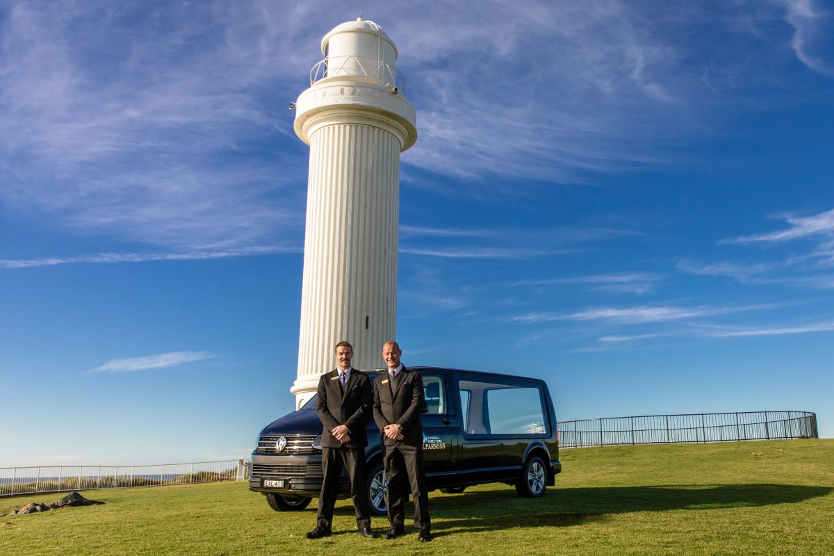 Alan and Anthony Parsons with one of their funeral vehicles at Wollongong Lighthouse.