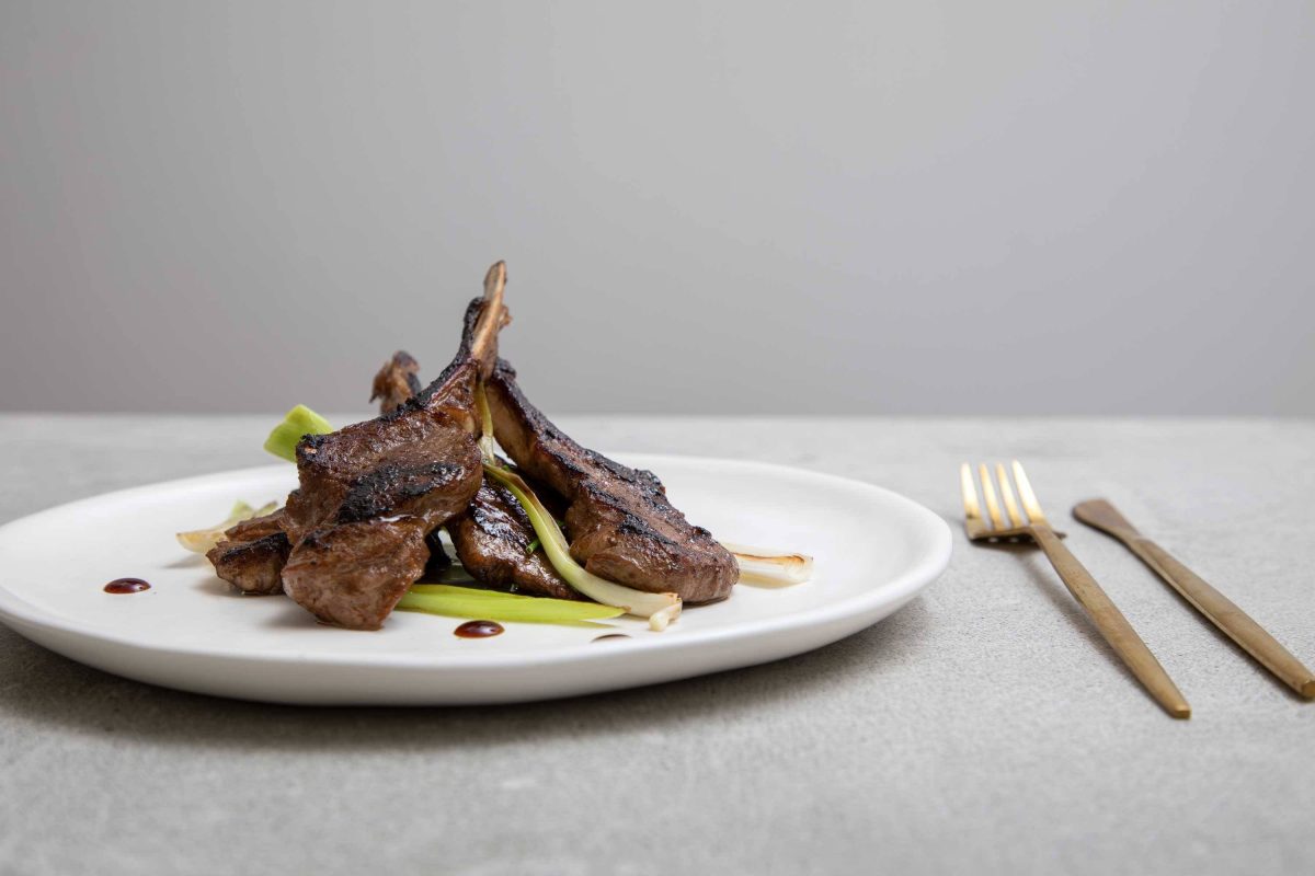 Hoisin-glazed lamb cutlets with poached shallots and onion puree