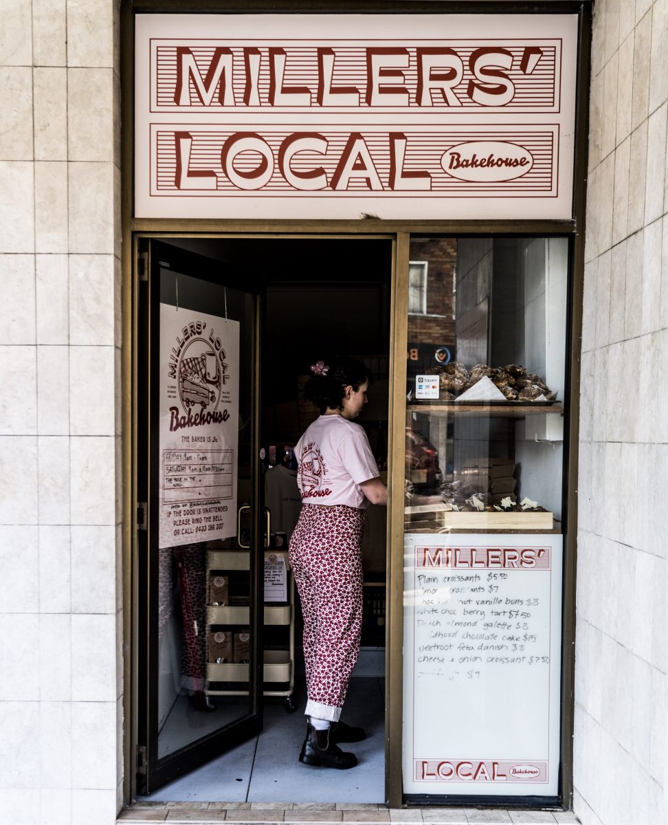Young woman in bakery doorway