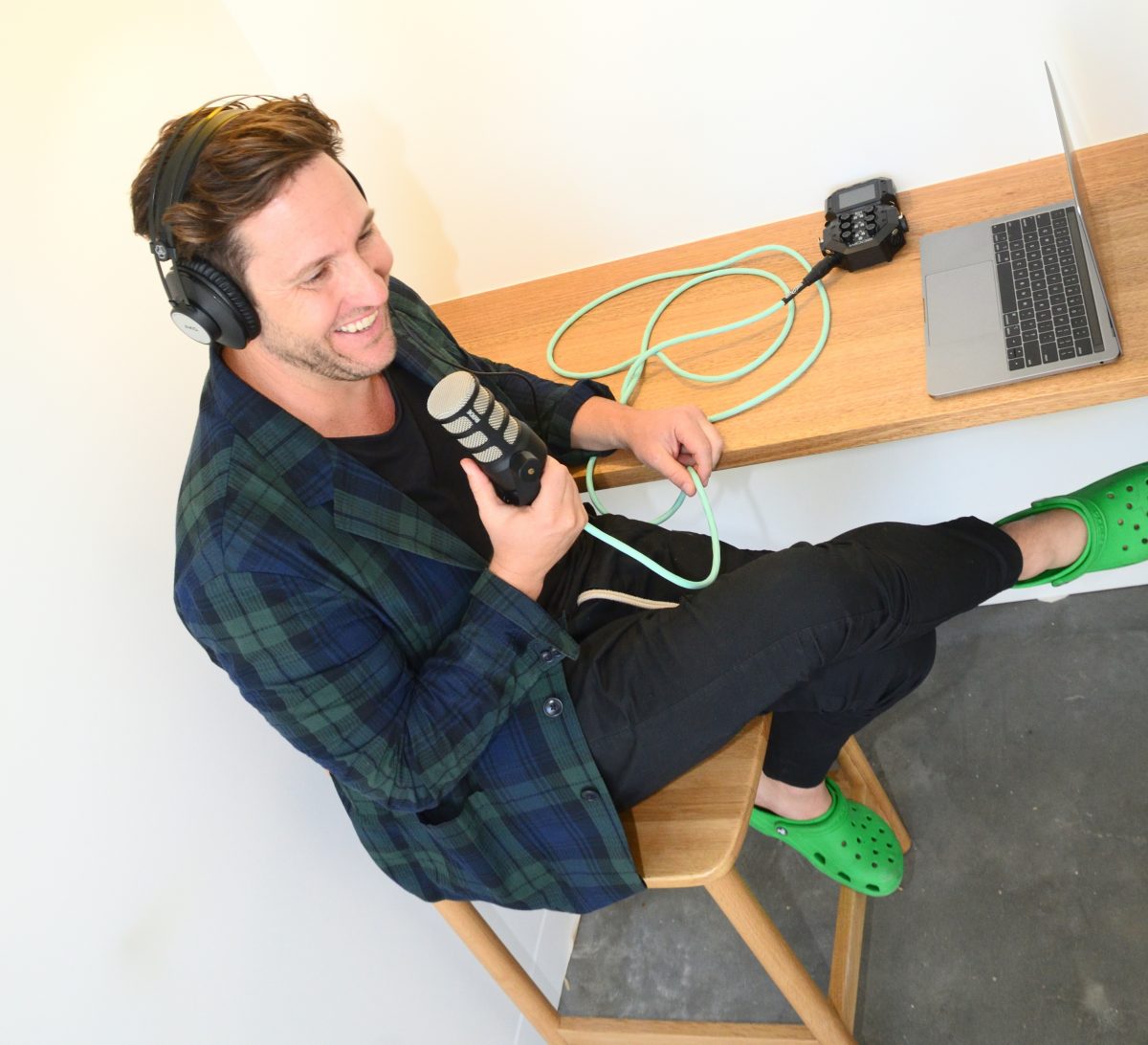 Heath Piper from Playback Interviews sitting at a desk with a microphone and a laptop