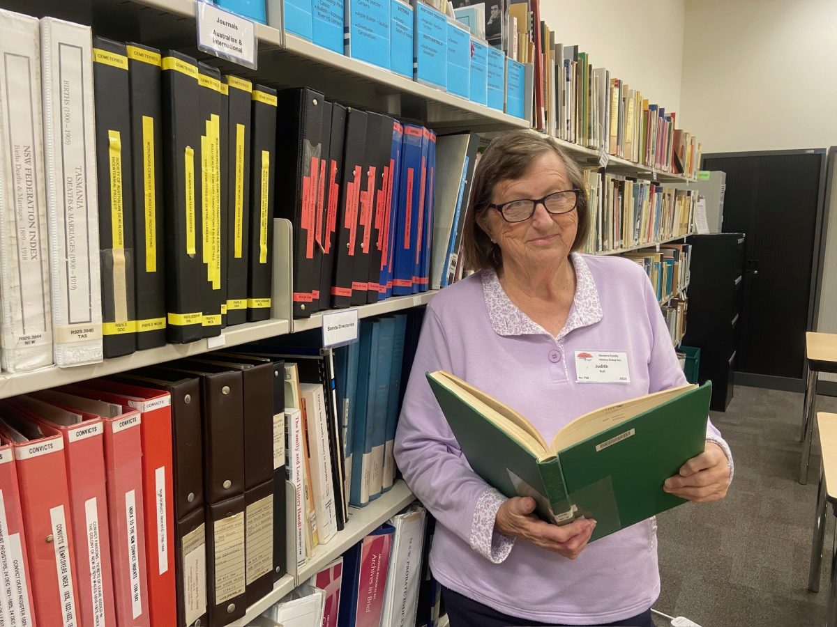 Illawarra Family History Group president Judy Bull looks at a records book at Wollongong Library