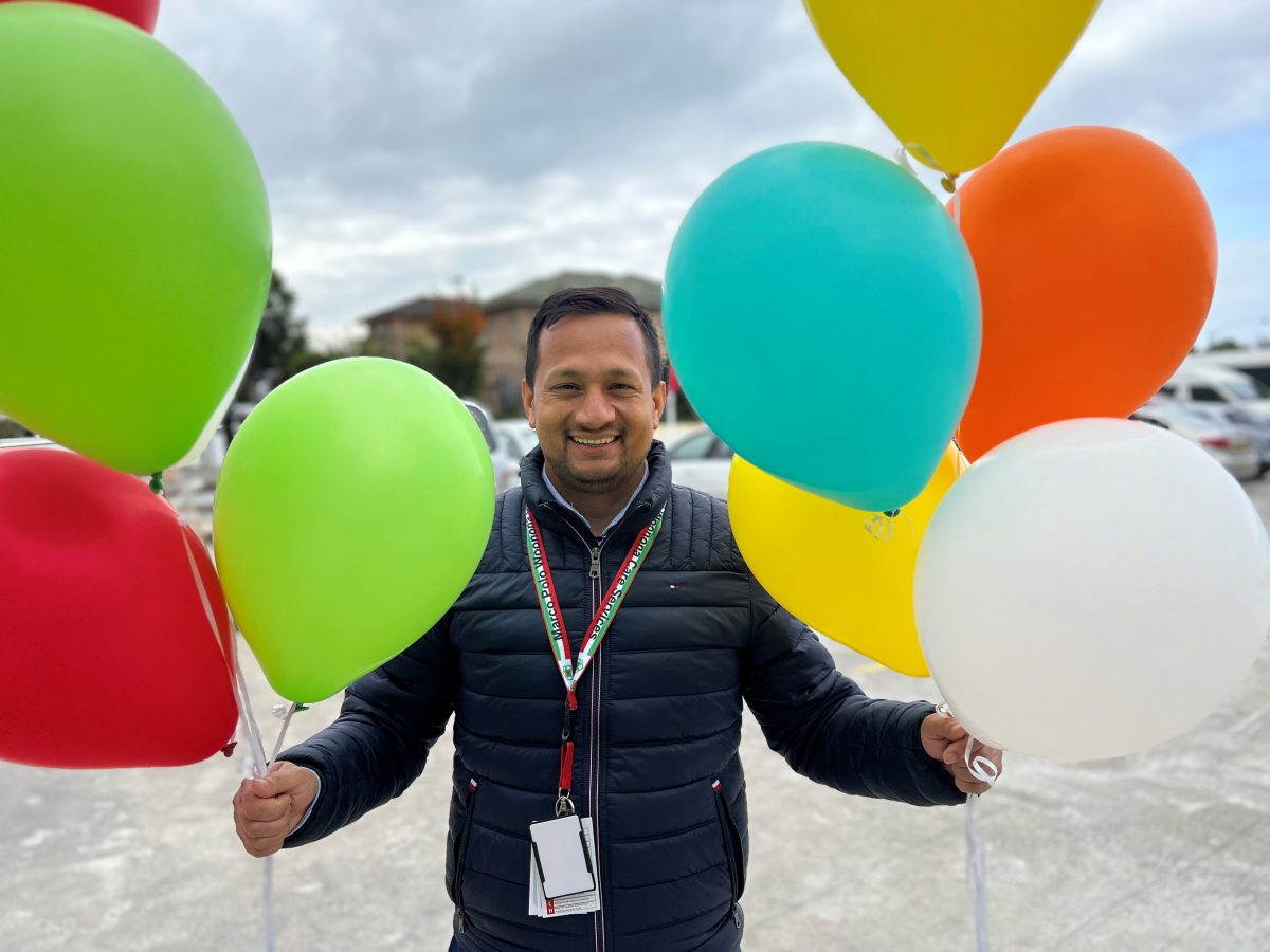 Marco Polo aged care worker with balloons.