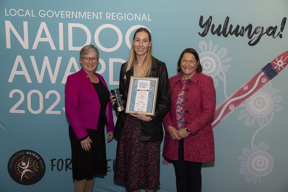 Young Achiever of the Year Emma McMahon stands with two other women at the Local Government Regional NAIDOC Awards 2023