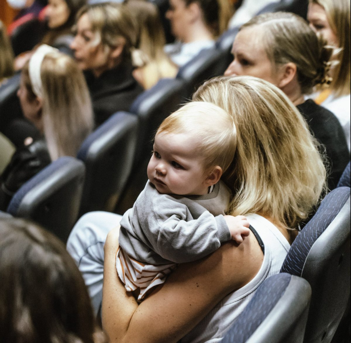 Woman and baby in crowd at UOW better births conference.