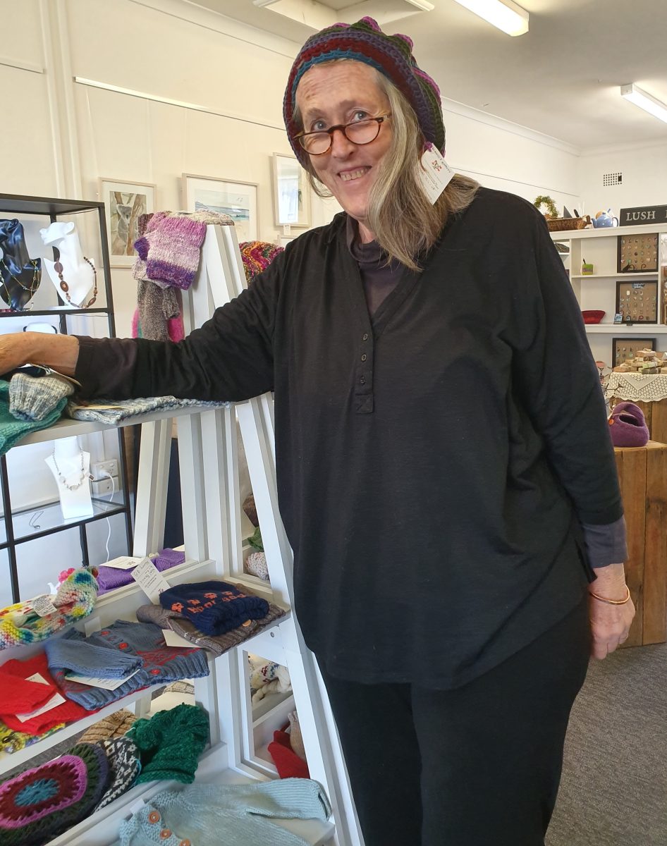 Kerry Butt wearing a knitted beanie in a craft shop.