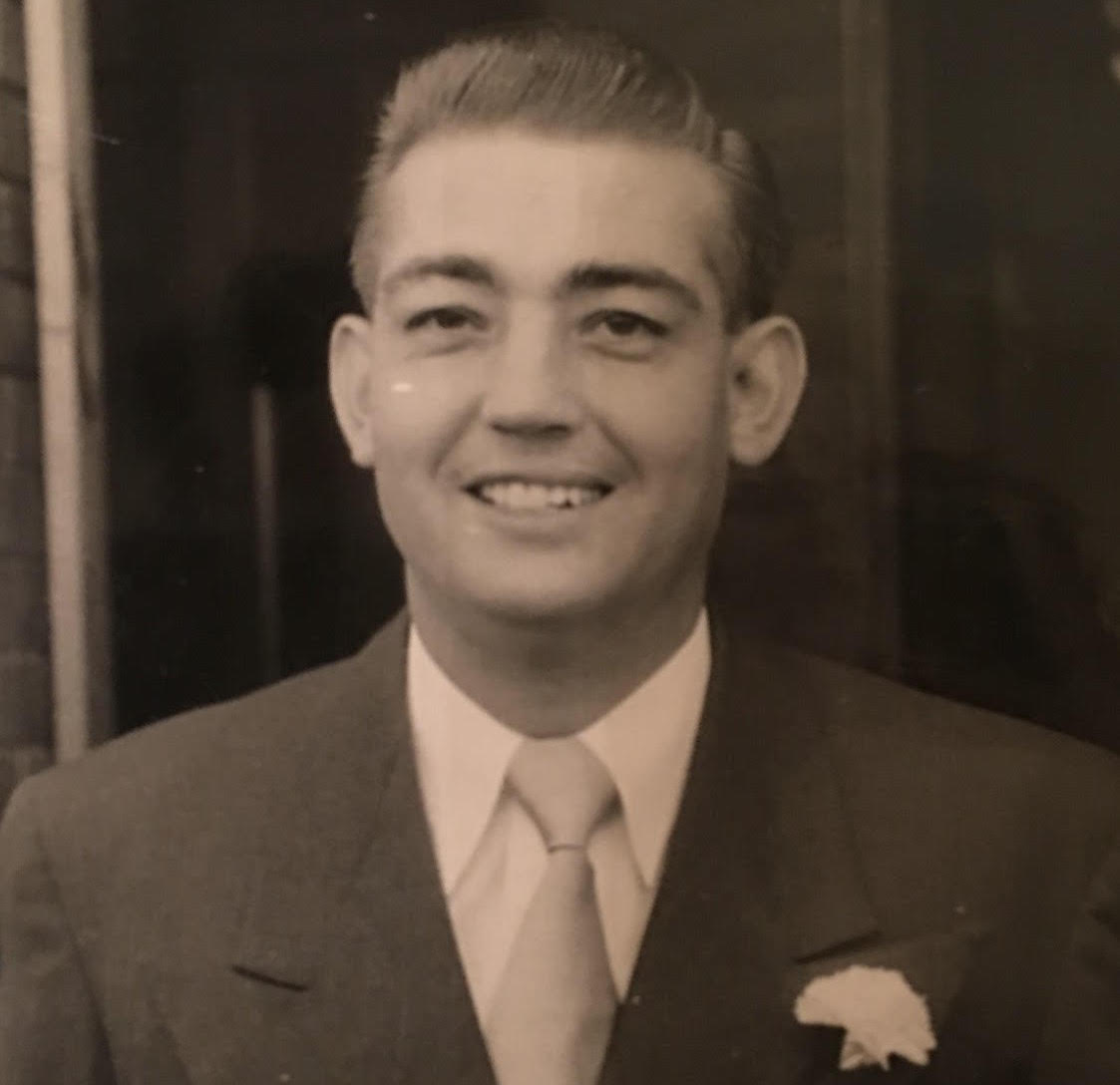 Black and white photo of adult man in a suit