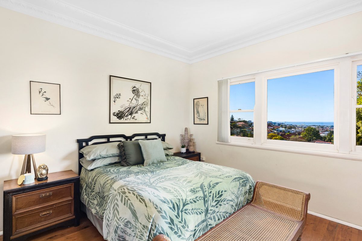 Bedroom with glimpses of ocean at 50 McKenzie Avenue in Wollongong 