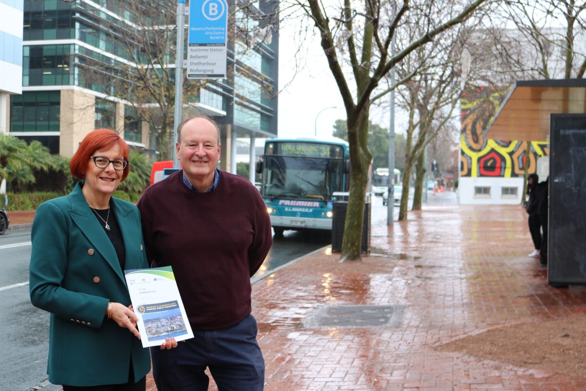 RDA CEO Debra Murphy and Policy Manager Alex Spillett with a bus in the background.