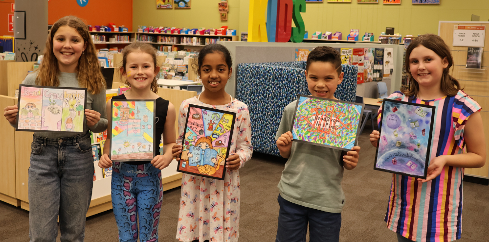 Five children with their prize-winning artworks.