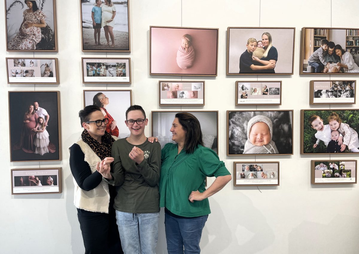 two women and a boy at photo exhibition 