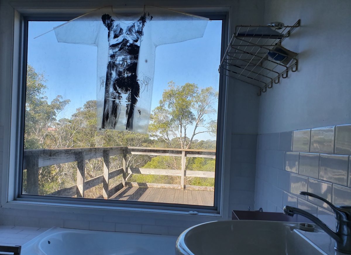 Liz's body print, framed within a transparent plastic T-shirt.