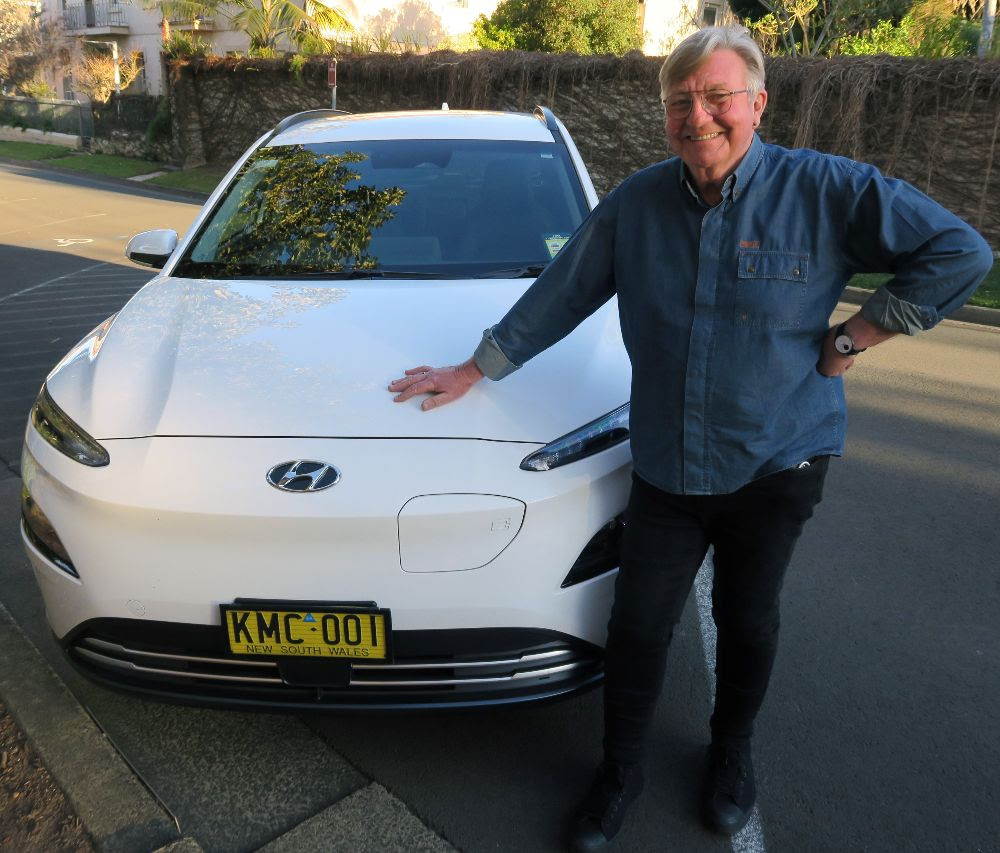 Kiama Mayor Neil Reilly standing next to his council electric vehicle.