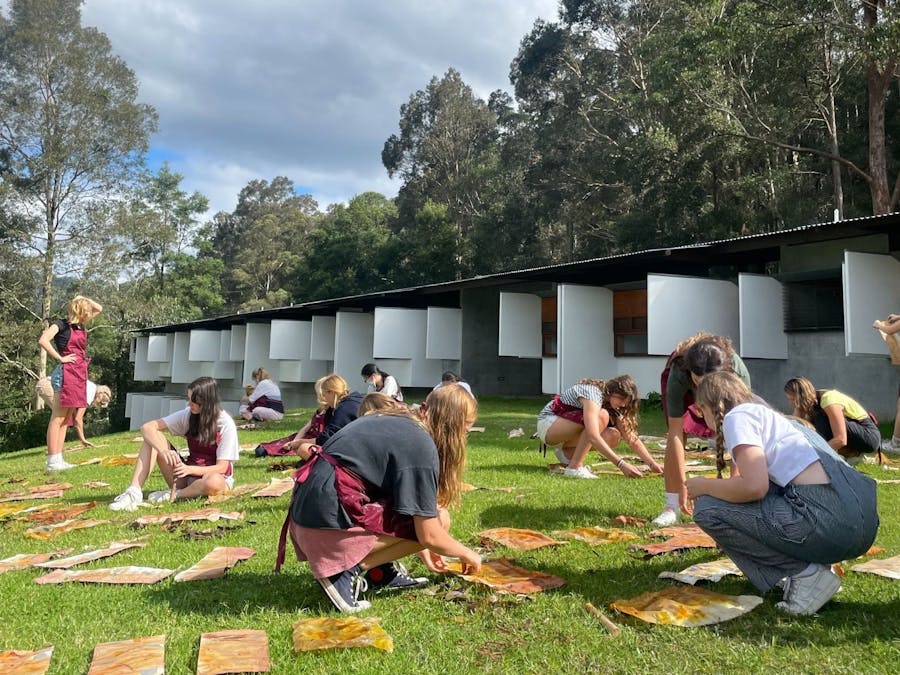 Youths making art with nature on the grass