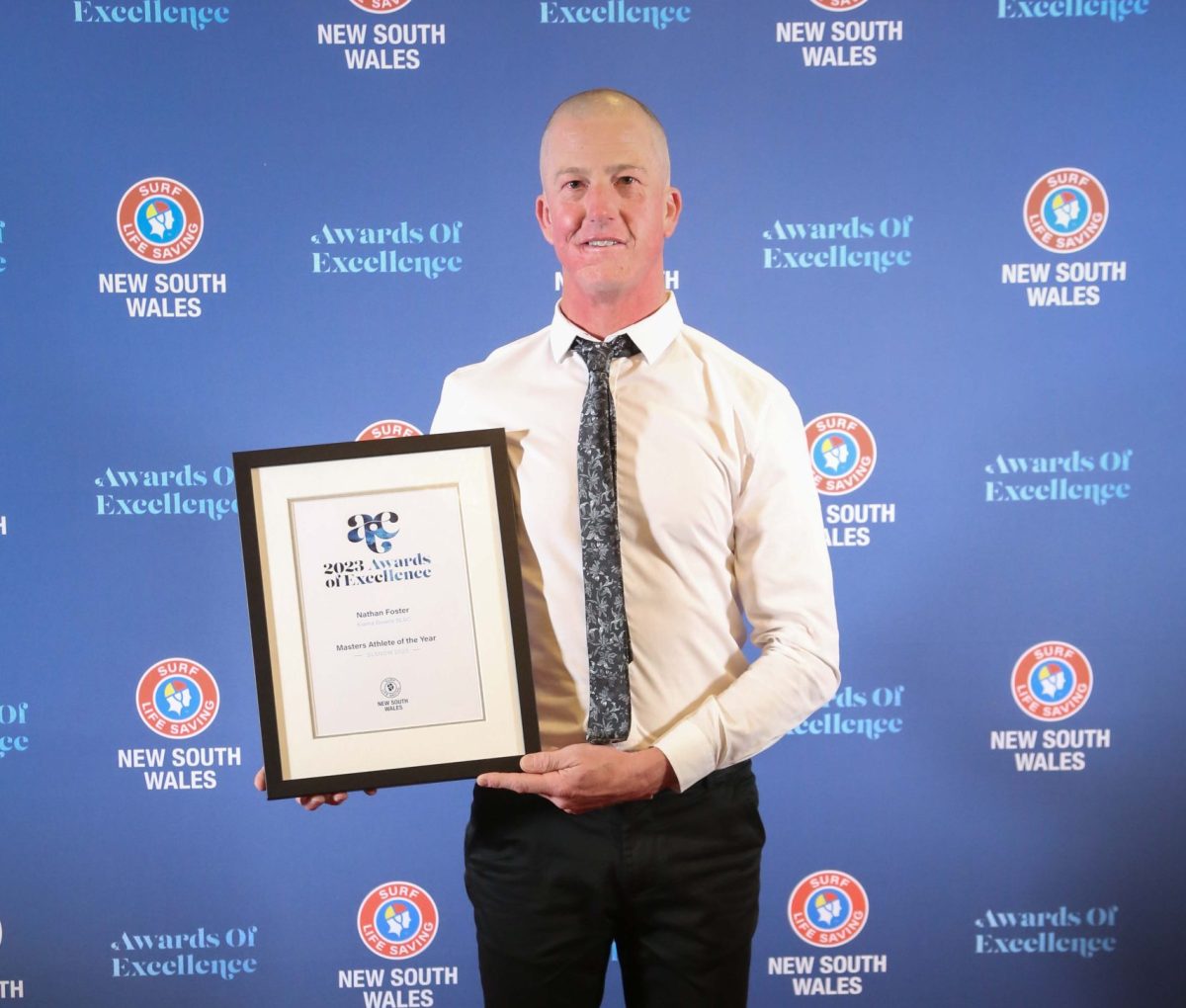 Nathan Foster of Surf Life Saving Kiama Downs holding an award at the Surf Life Saving NSW Awards of Excellence
