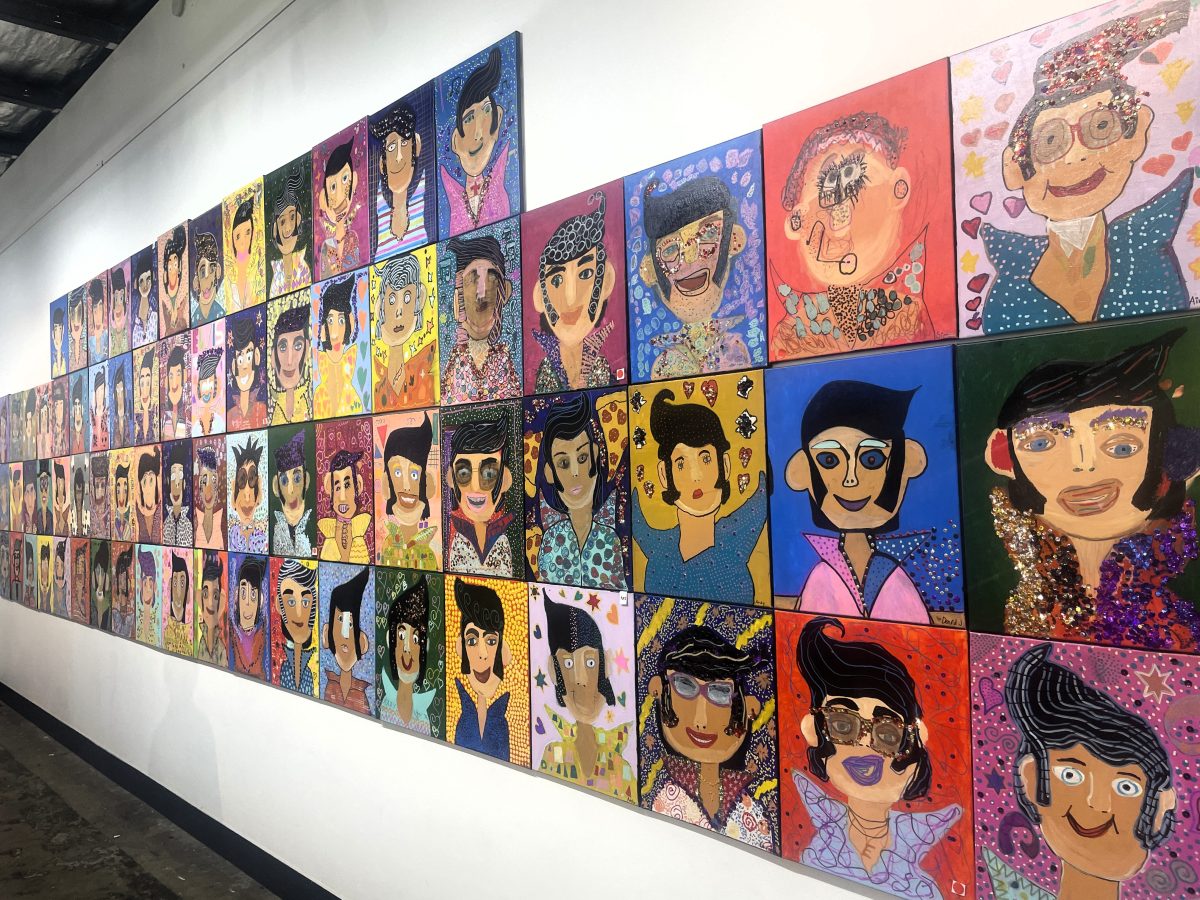 Wall of Elvis portraits.