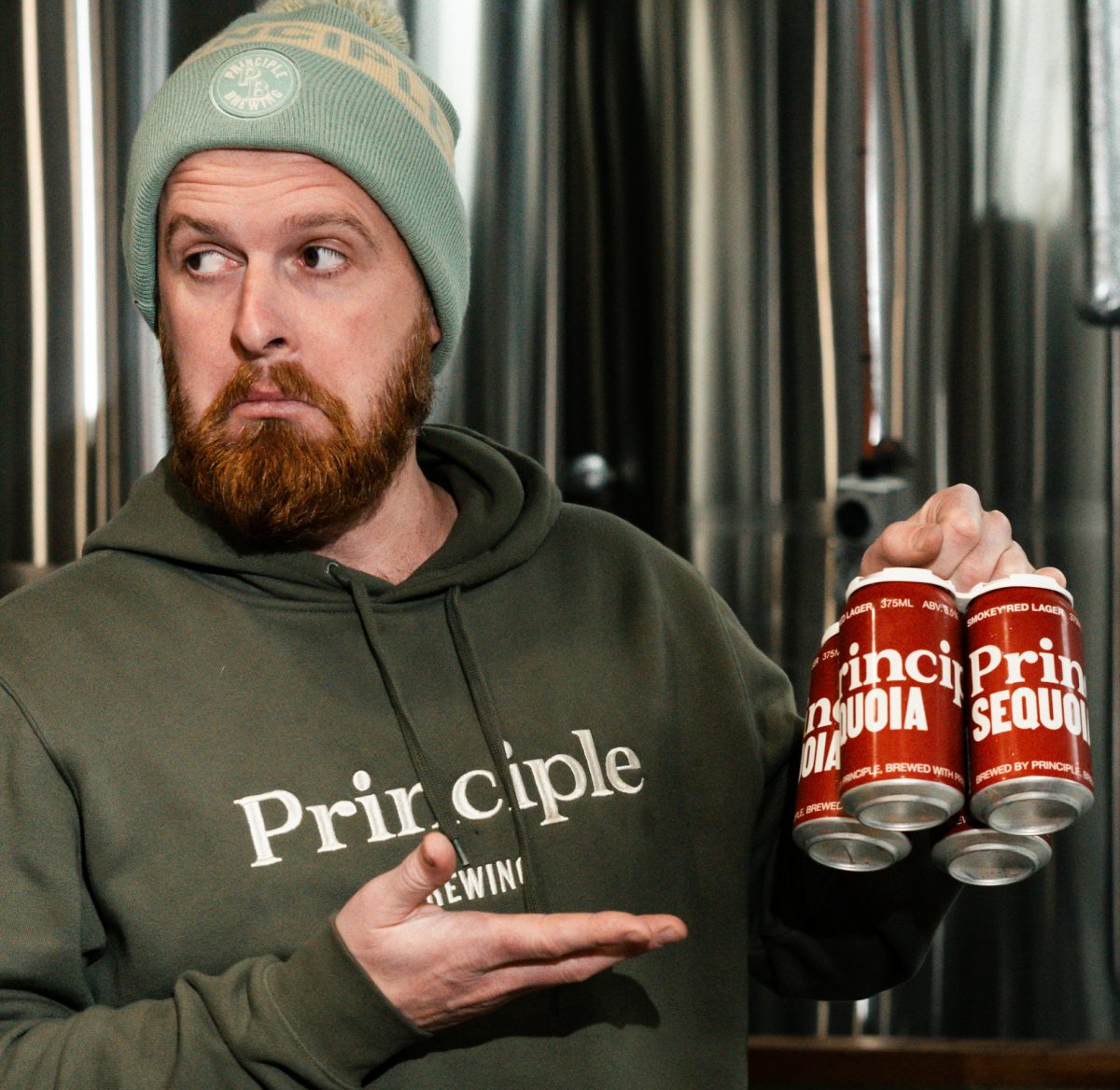 Principle Brewing Director David Mason with cans of beer. 
