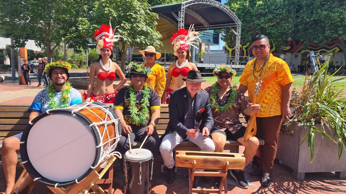 Mayor Gordon Bardbury plays drums with Cook Island dance group Inangaro Paradise