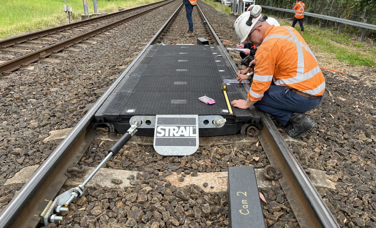 Rail workers installing a VeloSTRAIL panel.
