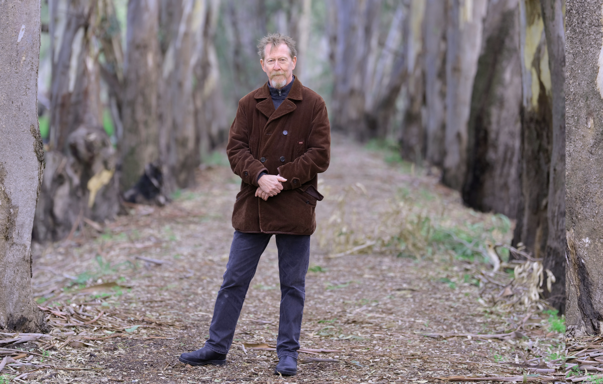 Author Chris Hammer stands among trees