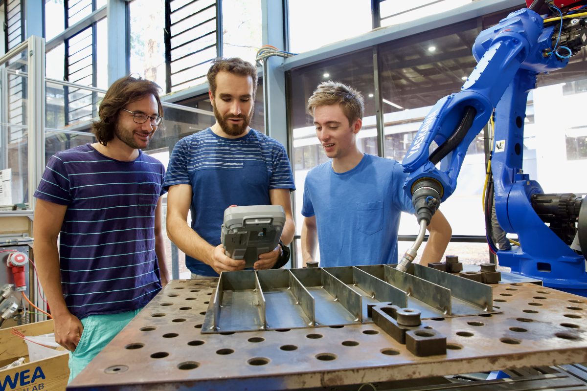 Verbotics team members Nathan Larkin, Andrew Short and Win Holzapfel with a welding robot.