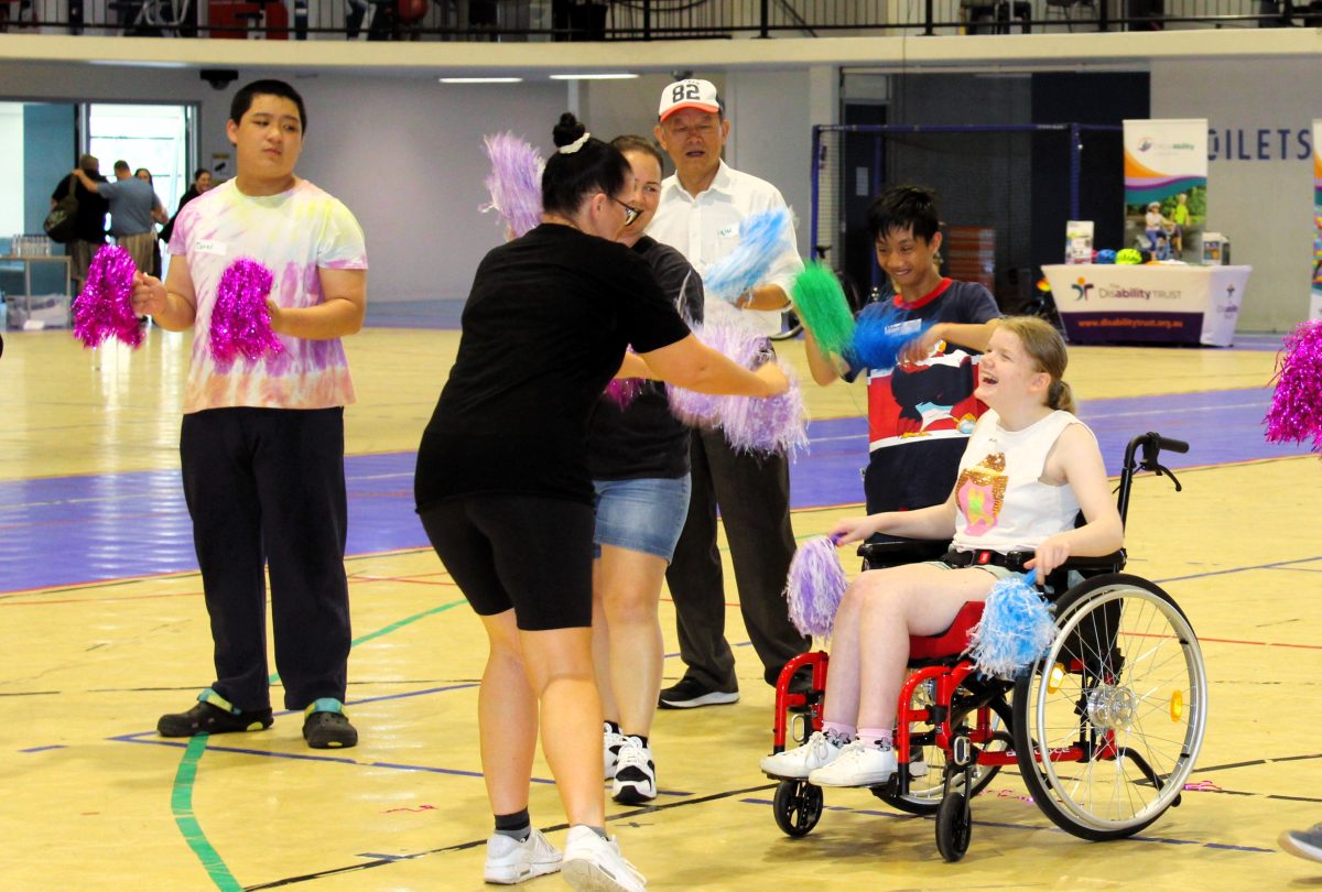 Zoe McCarthy from Zoe's School of Dance at UOW Sports Hub dancing with participants in the Inclusive sports day. 