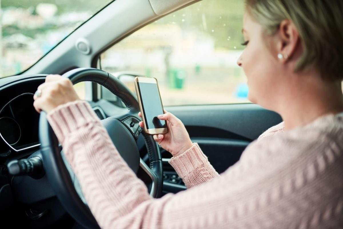 Woman using her mobile phone while driving