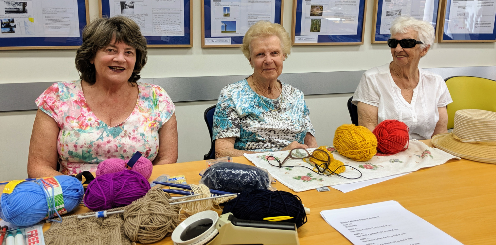 Three vision impaired women make creations from yarn