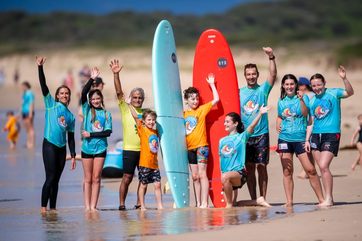 People cheering on the beach at surfing event