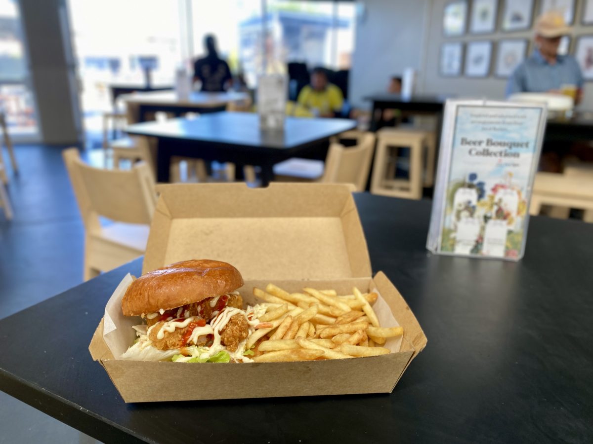 Tasty looking burger with chips in a cardboard box.
