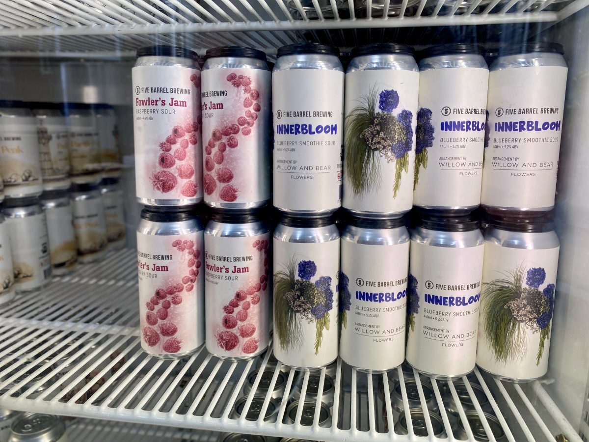 Cans of beer with floral artwork.