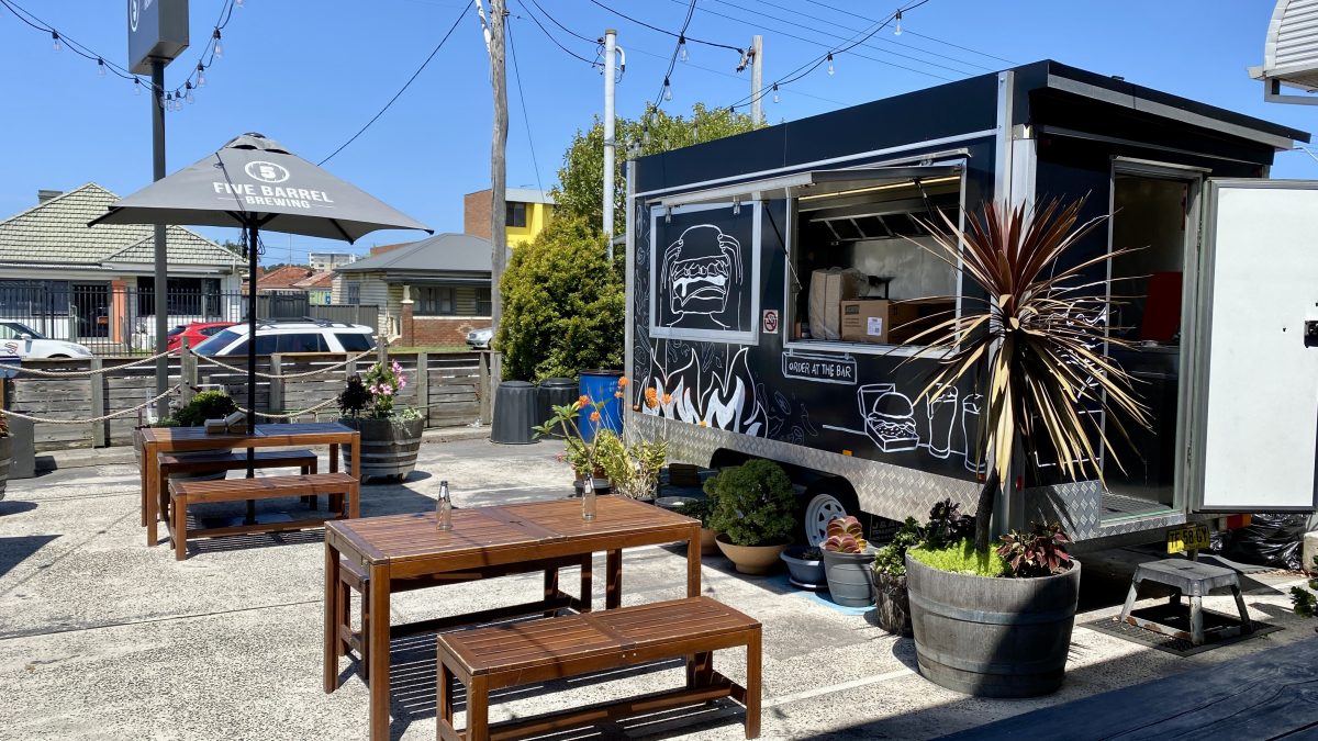 Food truck in outdoor seating area.