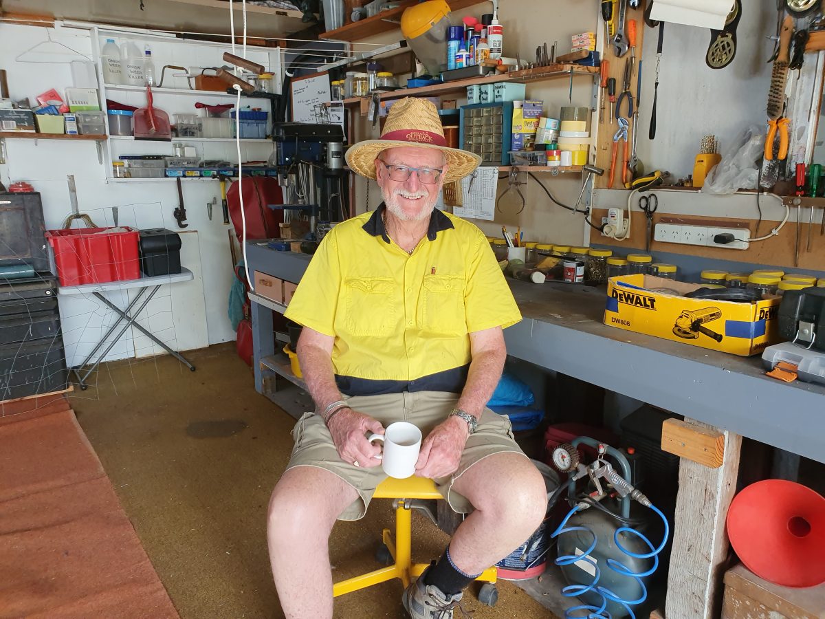 man with cuppa in his workshed