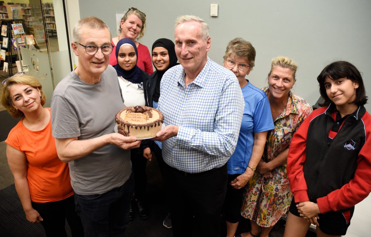 MCCI volunteers mark 10th anniversary with a cake.