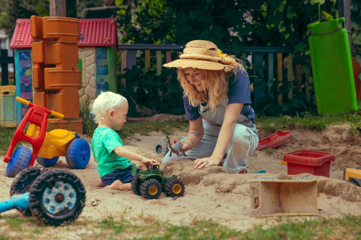 Alana and son Rafferty playing in a sand pit.