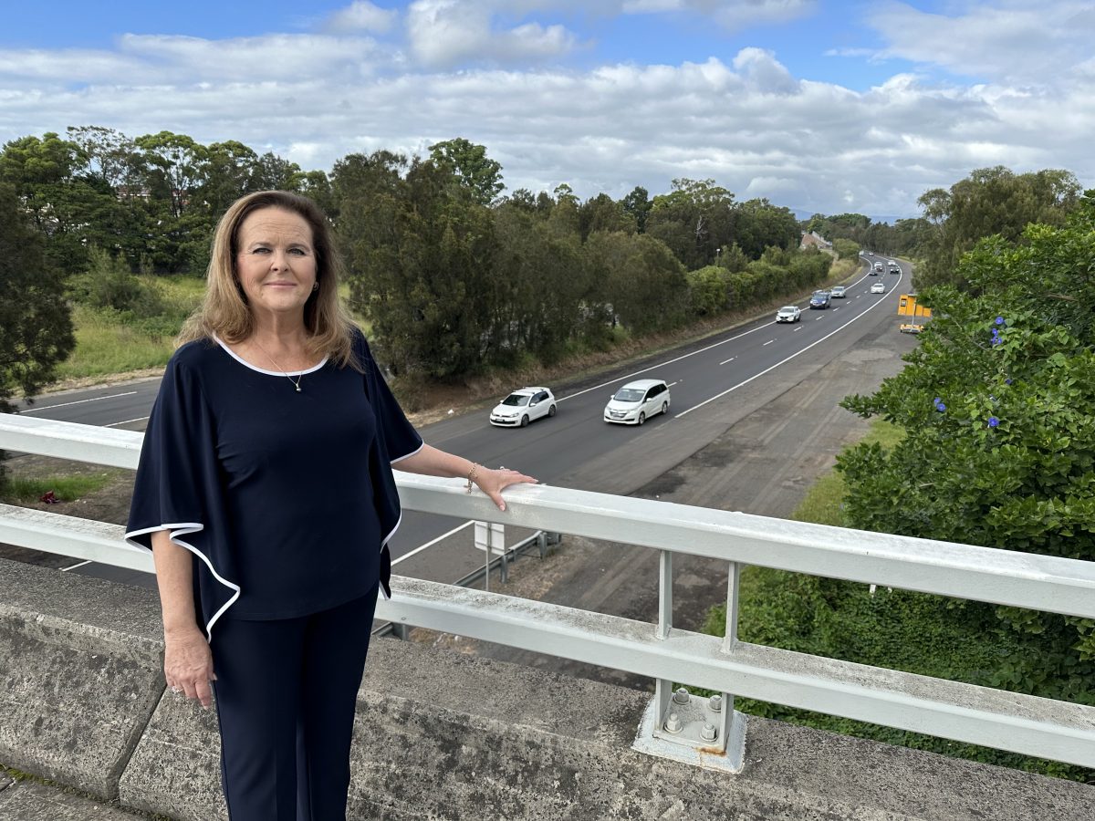 woman standing on overpass