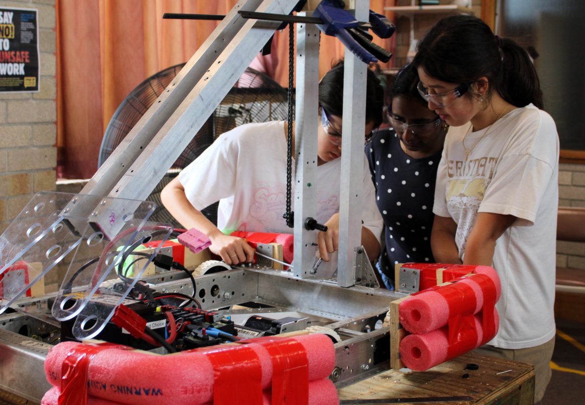 Female students working on robot.